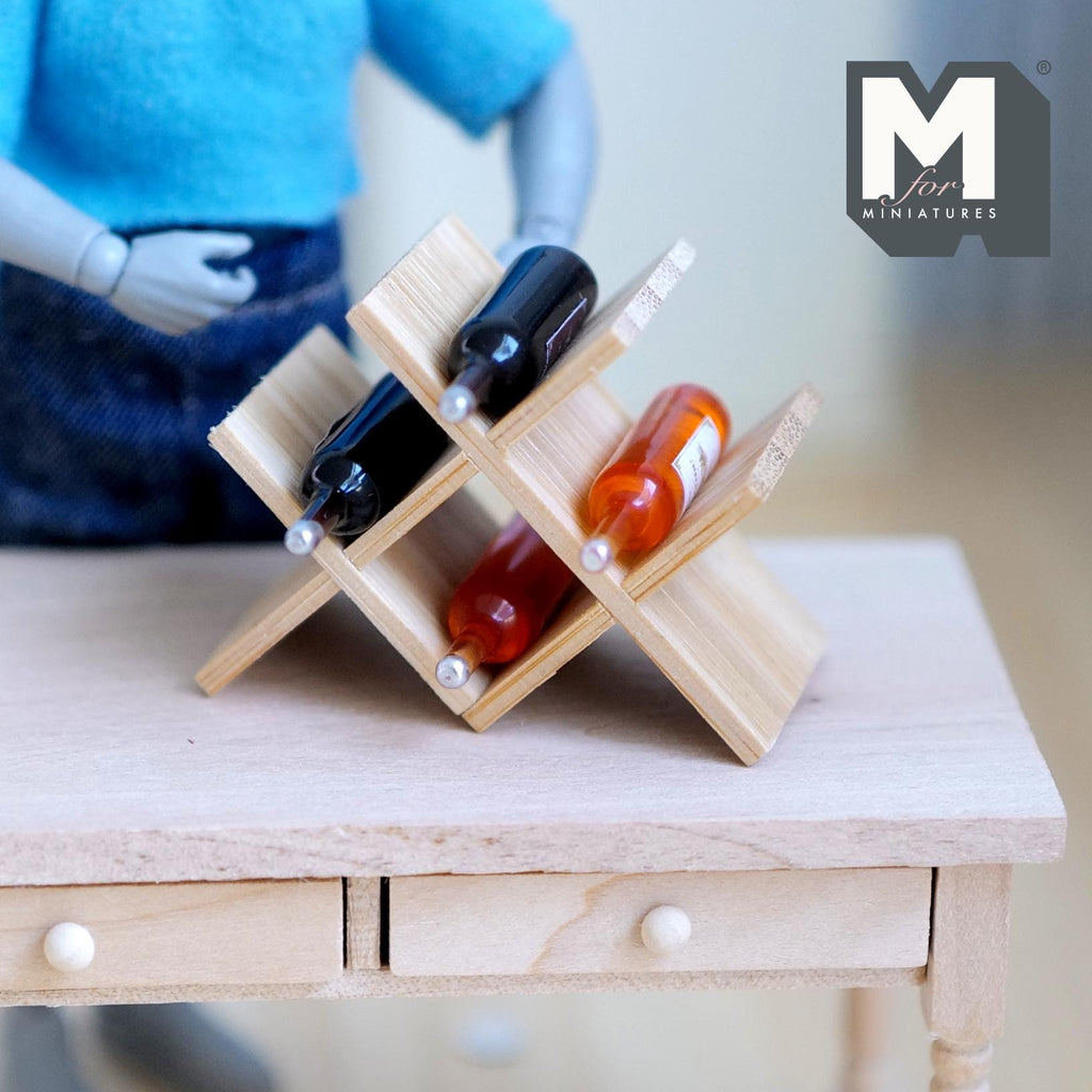 1:12 scale miniature bamboo X style wine rack with 4 wine bottles, shown on a wood table with an artist figure
