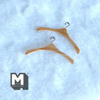 1:12 scale miniature wood clothes hangers with metal hooks, set of 2, natural wood grain, shown on white fur