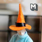 1:12 scale miniature Halloween witch hat in orange felt with black ribbon band, shown worn by a poseable figure