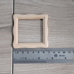 1:12 scale miniature square scalloped edge photo frame with glazing and backing, ready to paint wood, shown with a ruler