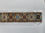 1:12 scale miniature fabric stair runner in blue and red with printed tile pattern and gold border, shown in its bag