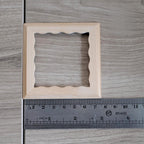 1:12 scale miniature square scalloped edge photo frame with glazing and backing, unfinished wood, shown with a ruler