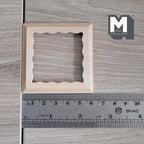 1:12 scale miniature square scalloped edge photo frame with glazing and backing, ready to paint wood, shown above a ruler