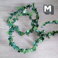 1:12 scale miniature ivy green leaf garland with bendable wire stem, cut to length, shown coiled on a gray surface