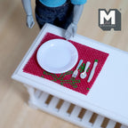 1:12 scale miniature place setting with red placemat, white plate and cutlery, set of 5, shown on a white table