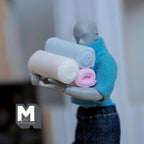 1:12 scale miniature rolled towels in pink, blue and white, set of 3, shown carried by an artist figure