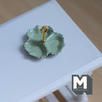 1:12 scale miniature 3 compartment scalloped dish in mint green with a gold center handle, shown on a white table