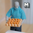 1:12 scale miniature egg tray with 12 brown eggs, shown held by an artist figure