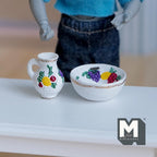 1:12 scale miniature resin fruit motif pitcher and bowl set in white with painted fruit, set of 2, shown on a white table