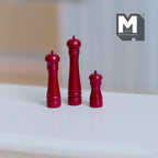 1:12 scale miniature salt and pepper grinders in red, set of 3 in graduated heights, shown on a white table