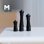 1:12 scale miniature salt and pepper grinders in black, set of 3 in graduated heights, shown on a white table