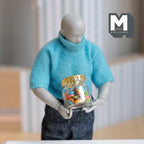 1:12 scale miniature fruit rings cereal in a glass jar with gold lid, colorful rings, shown held by an artist figure