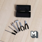 1:12 scale miniature metal tool box in black with 6 tools including screwdriver, wrench and hammer, shown on a wood surface