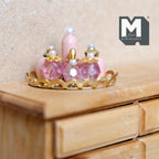 1:12 scale miniature perfume bottle vanity set on a metal tray, 8 pieces in pink and gold, shown on a wood dresser