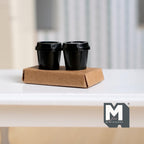 1:12 scale miniature takeaway coffee cups in black with a kraft drink carrier, set of 3, shown on a white table