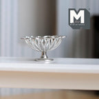 1:12 scale miniature wire fruit basket on pedestal, large, in silver with a petal shaped rim, shown on a white shelf