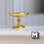 1:12 scale miniature metal pedestal cake stand, medium, in shiny gold with a turned stem, shown on a white shelf