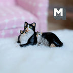 1:12 scale miniature cast resin tuxedo cat with two kittens, black and white mother lying down, shown on a white fluffy rug