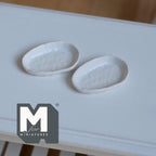 1:12 scale miniature irregular textured plates in white, style B, set of 2, long oval shape shown on a white table