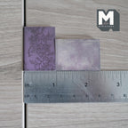 1:12 scale miniature novels with blank pages, set of 8, purple covers with an embossed floral design, shown with a ruler