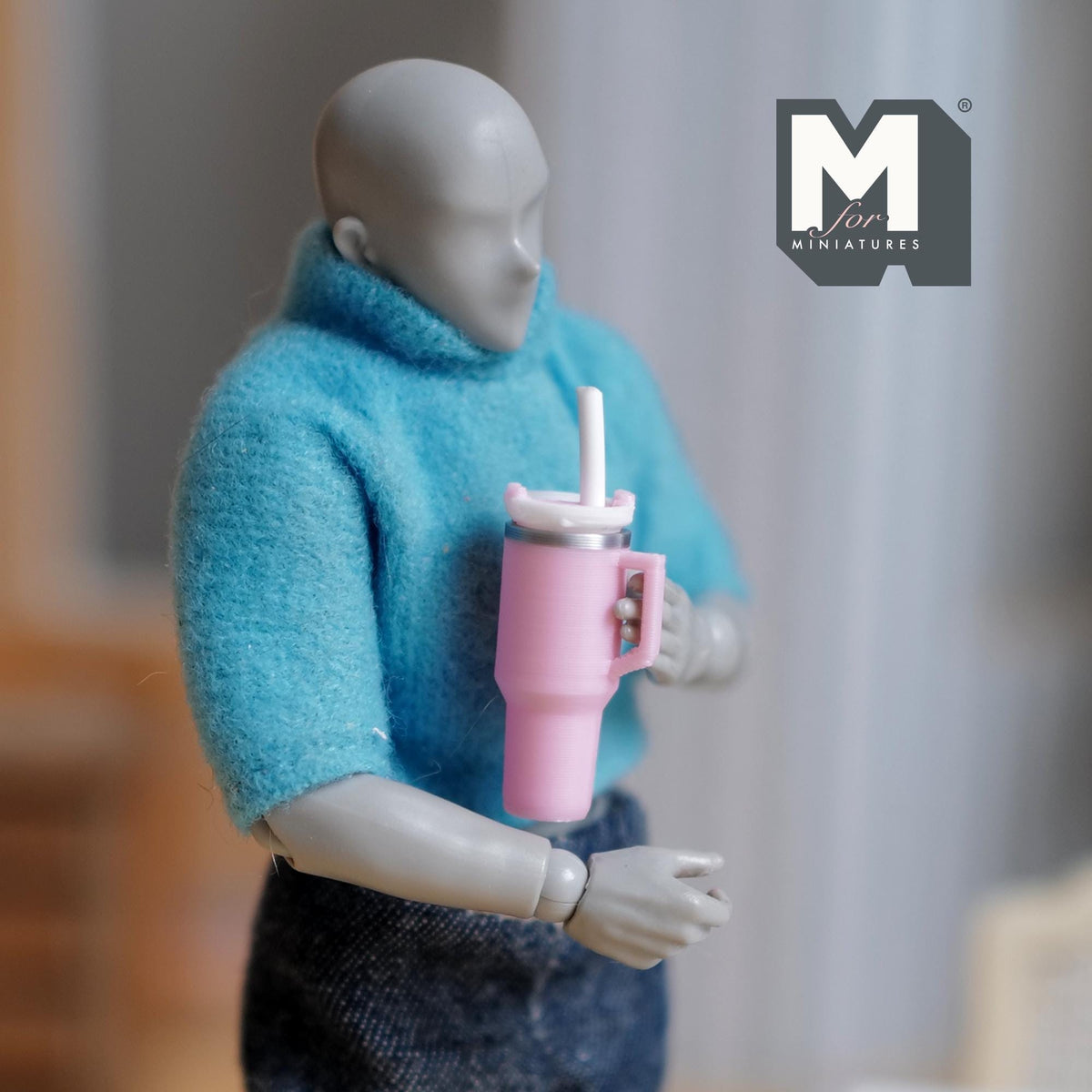 1:12 scale miniature tumbler with straw and handle in pink, held by a figure for scale