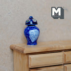 1:12 scale miniature ceramic ginger jar with lid in blue and white with a swirl pattern, shown on a wood dresser