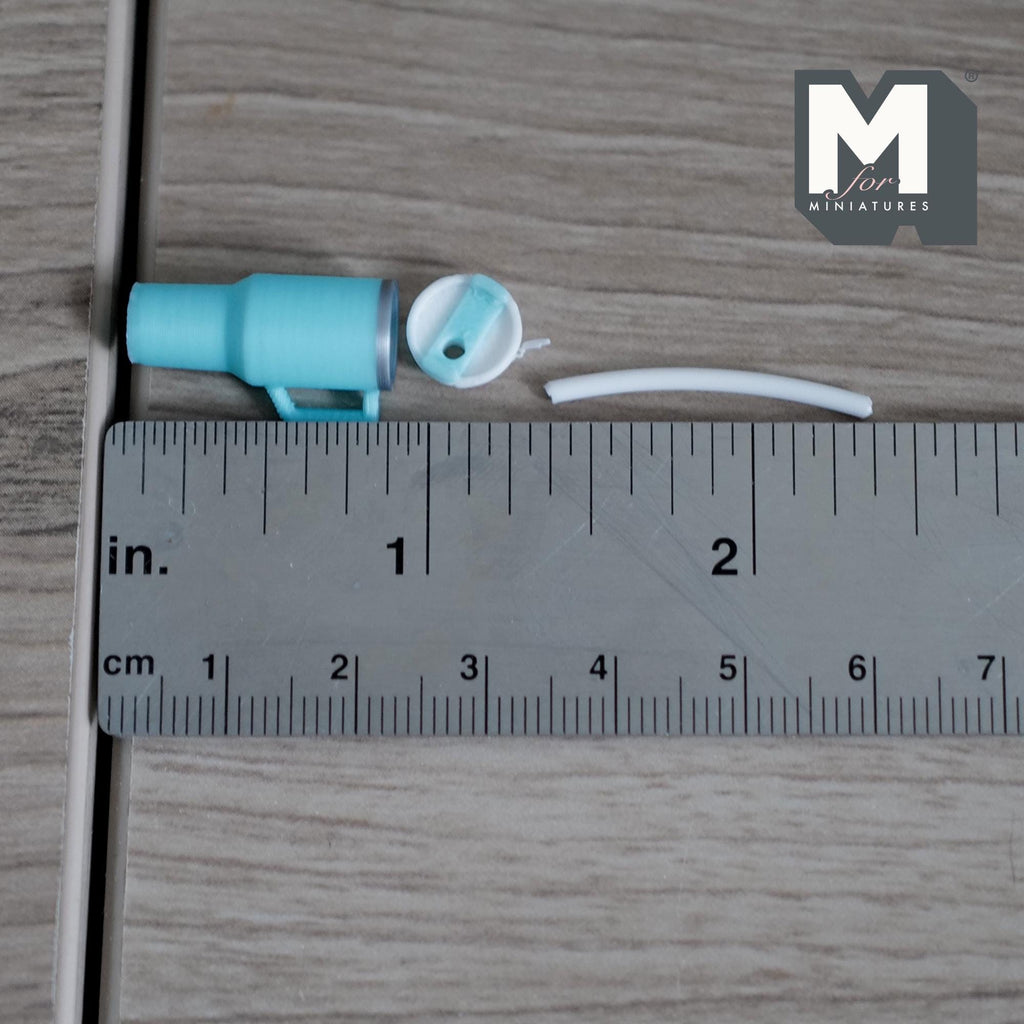 1:12 scale miniature tumbler in aqua blue next to a ruler, 7/8 inch tall