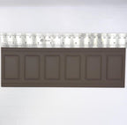 1:12 scale miniature raised rectangle wainscot panel in dark brown, 6 panels in a row, shown with a ruler