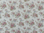 1:12 scale miniature rose floral wallpaper in pink, clusters of pink and blue flowers with green leaves on cream