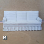 1:12 scale miniature 3 seater sofa with skirt in white textured fabric, three seat and back cushions with a pleated base