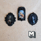 1:12 scale miniature oval portraits with dog, cat and gentleman in ornate black frames, set of 3, shown on a wood surface