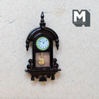 1:12 scale miniature vintage style drop wall clock in dark brown, non working, white dial and gold pendulum, hung on a wall