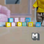 1:12 scale miniature wood number blocks, set of 10, pastel pink, blue and yellow cubes shown stacked beside a doll