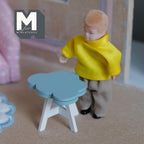1:12 scale miniature wood cloud table kit in dusty blue with white legs, shown assembled beside a boy doll