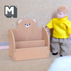 1:12 scale miniature wood bear 2 tier bookshelf kit in brown with a bear face back, assembled, beside a boy doll