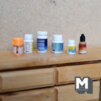 1:12 scale miniature empty bottles with lids, set of 6, assorted vitamin and dropper style bottles on a wood dresser
