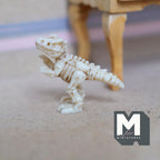 1:12 scale miniature standing T rex skeleton in ivory bone color, upright pose with long tail, shown beside furniture