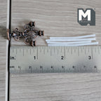 1:12 scale miniature ornate metal candelabra in dark bronze with 3 white taper candles, shown lying flat with a ruler