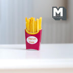 1:12 scale miniature french fries in a red box with a white label, golden fries standing upright, shown on a white table