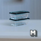 1:12 scale miniature food storage containers with lids in teal, set of 2, clear rectangular boxes stacked on a white table