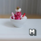 1:12 scale miniature strawberry ice cream sundae in a white ceramic bowl, pink scoops with a candy stick and strawberry