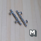 1:12 scale miniature ornate long French door pull handles in silver, set of 2, embossed grips on a wood surface