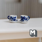 1:12 scale miniature ceramic cups and saucers with blue brushstroke leaves on white, set of 4, shown on a white table