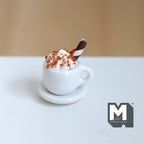 1:12 scale miniature hot chocolate with whipped cream and chocolate stick in a white cup on a saucer