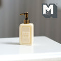 1:12 scale miniature soap pump bottle in beige with copper pump and raised pure soap lettering, on a white table