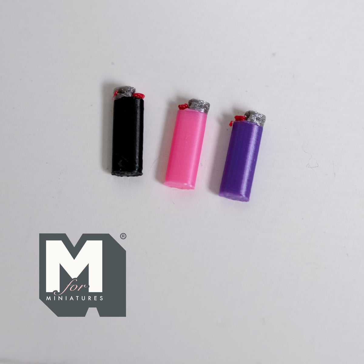 1:12 scale miniature non working lighters in assorted colors, set of 3, black, pink and purple, on a white surface