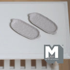 1:12 scale miniature metal oval plates in warm gray, set of 2, long platters with small handles, on a white table
