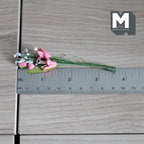 1:12 scale miniature pink lily flower bunch with white filler flowers and green stems, shown with a ruler