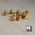 1:12 scale miniature globe bells in gold, set of 10, larger round bells with loops shown on a light wood surface