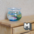1:12 scale miniature round fish bowl with koi and plants in resin, wavy rim and blue water, shown on a wood dresser